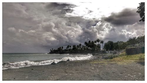 Scenic view of sea against cloudy sky