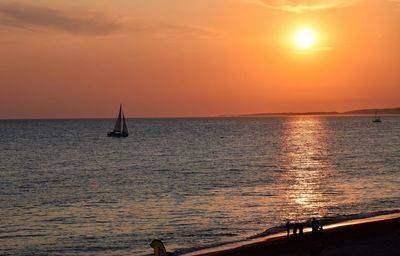 Scenic view of sea against orange sky