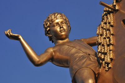 Low angle view of statue against clear blue sky