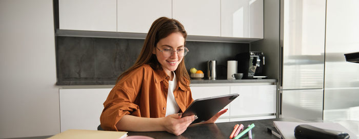 Young woman using laptop at home