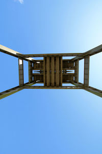 Low angle view of bridge against clear blue sky