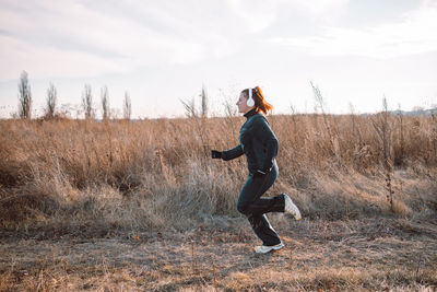 Full length of woman walking on field