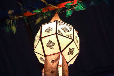 Close-up of illuminated lantern hanging on wall