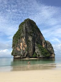 Scenic view of rocks on beach against sky