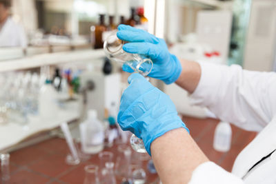 Midsection of scientist doing experiment in lab