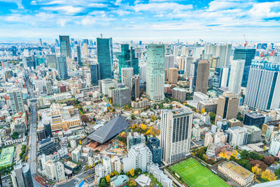 High angle view of modern buildings in city against sky