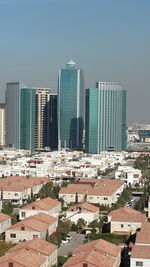 Modern buildings in city against clear sky