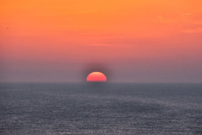 Scenic view of sea against orange sky during sunset