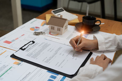 Midsection of businessman working on table