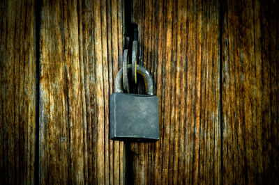 Close-up of padlock on wooden door