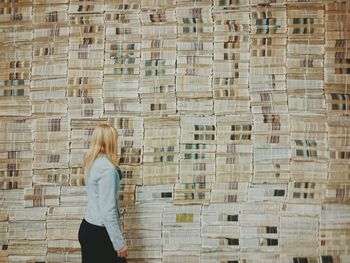 Side view of a woman walking by the wall