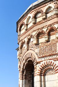 Low angle view of historical building against clear blue sky