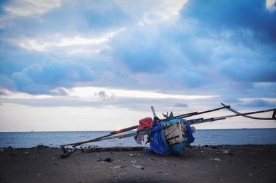 Nautical vessel on beach against sky