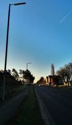 Empty road along trees