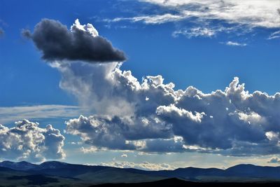 Low angle view of snowcapped mountains against sky