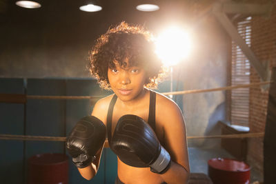 Portrait of young woman exercising in gym