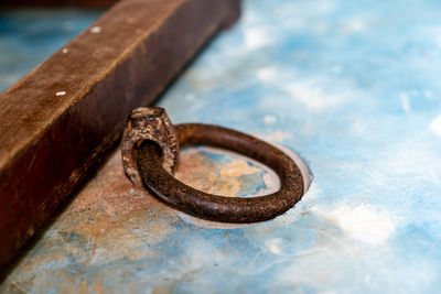 Close-up of rusty metal on wood