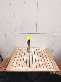 Person standing on wooden table against wall