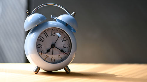 Close-up of clock on table at home