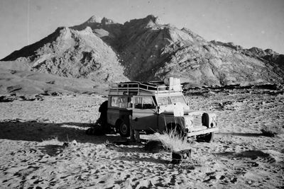 Built structure on desert against mountain range