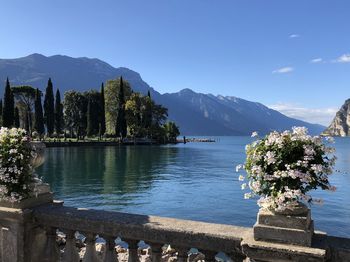 Scenic view of lake and mountains against blue sky