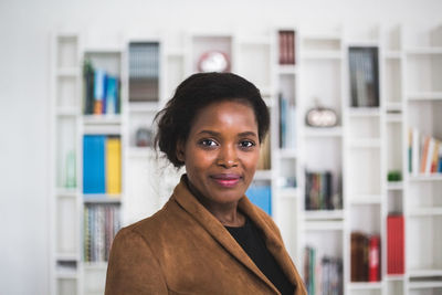 Portrait of confident female architect standing in home office