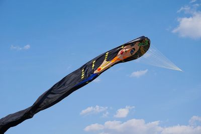 Low angle view of kite flying against blue sky