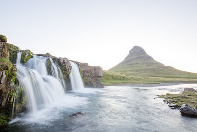 Scenic view of waterfall against clear sky