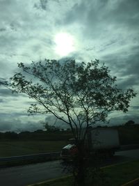 Scenic view of field against cloudy sky