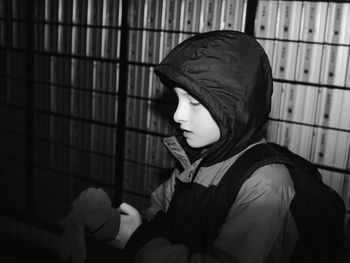 Side view of boy wearing gloves at night