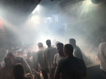 People enjoying music concert at night