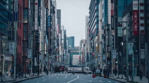 Panoramic view of city street and buildings against sky