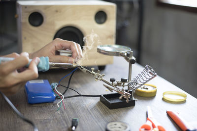 Close-up of hands working on table