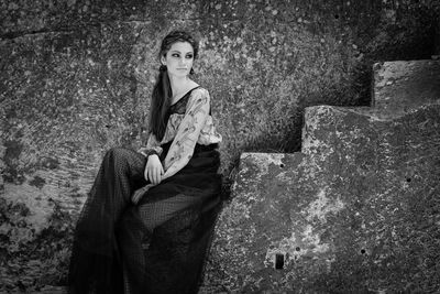 Portrait of a young woman sitting outdoors