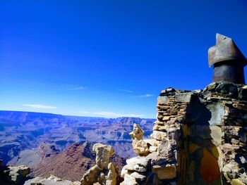 Scenic view of mountains against blue sky