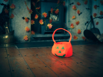 Close-up of pumpkin bag on wooden floor at home
