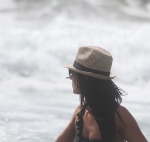 Woman wearing hat at sea