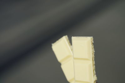 Close-up of white cup on table against black background