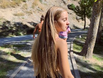 Close-up of teenage girl with plants in foreground