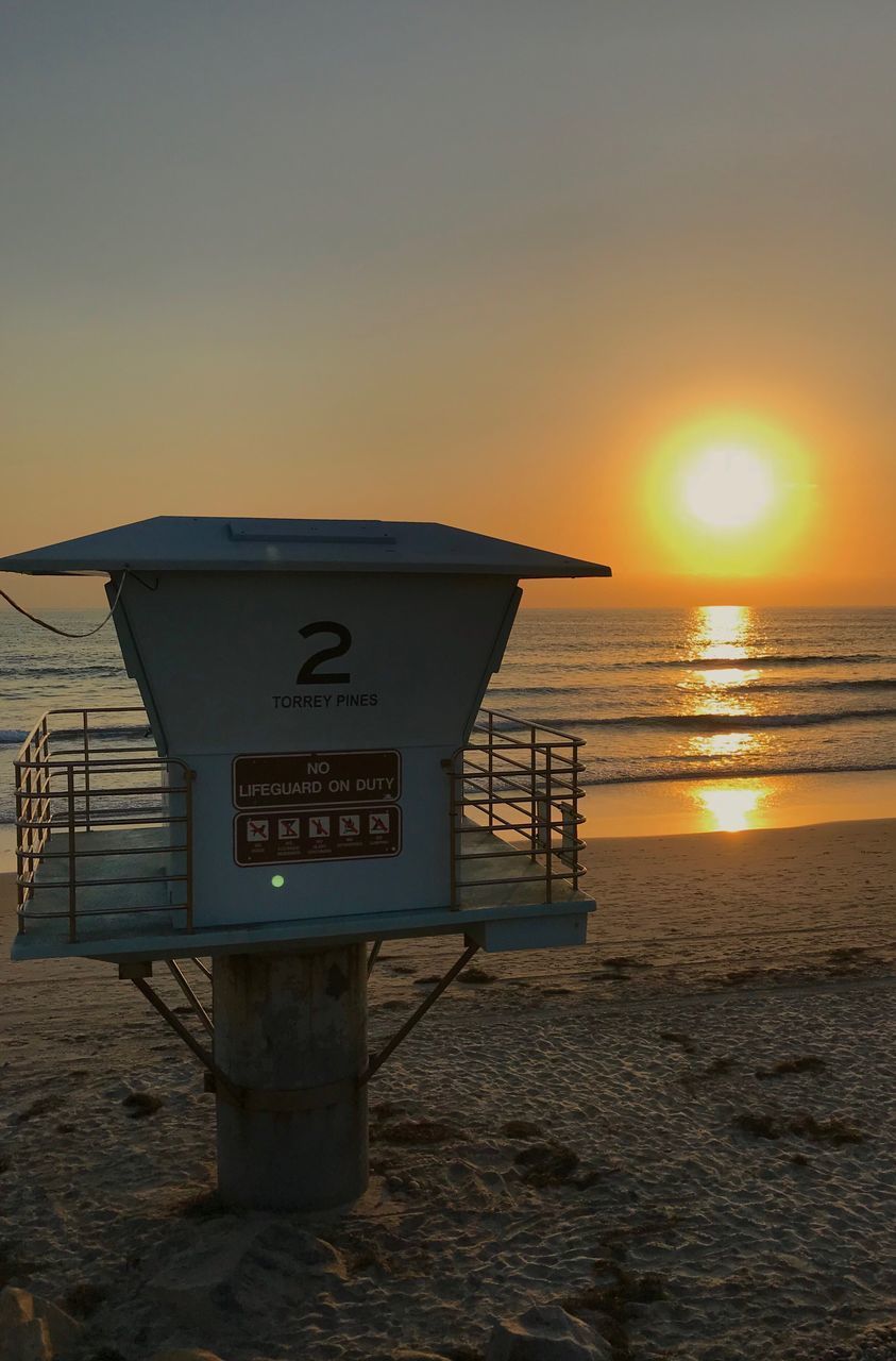 SCENIC VIEW OF BEACH AGAINST SKY DURING SUNSET