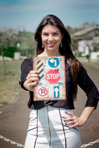 Portrait of a smiling young woman standing outdoors