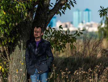 Portrait of young man standing in forest
