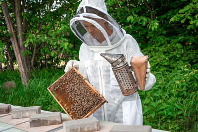 Midsection of man working on plants