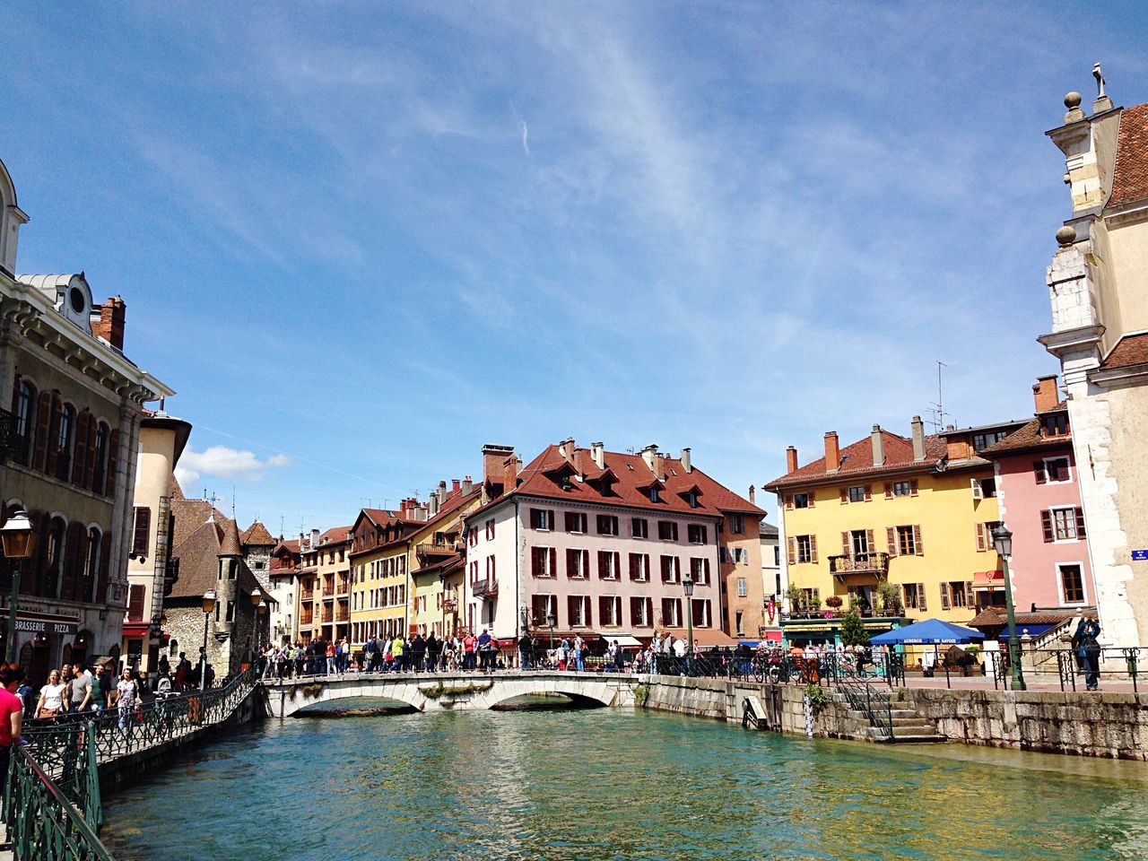 architecture, building exterior, built structure, water, waterfront, sky, canal, residential building, residential structure, city, nautical vessel, incidental people, building, house, residential district, city life, cloud, town, river, day