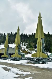 Built structure on snow covered field against sky