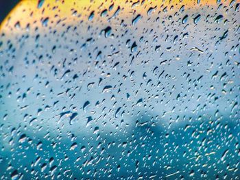Full frame shot of raindrops on glass window
