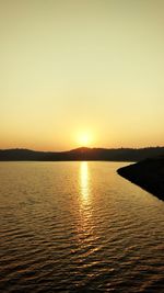 Scenic view of sea against clear sky during sunset