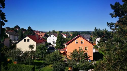 Houses against clear blue sky