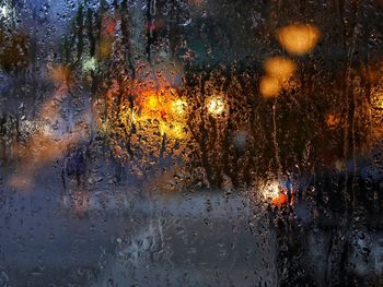 Rain drops on glass window at night