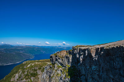 Scenic view of mountains against blue sky